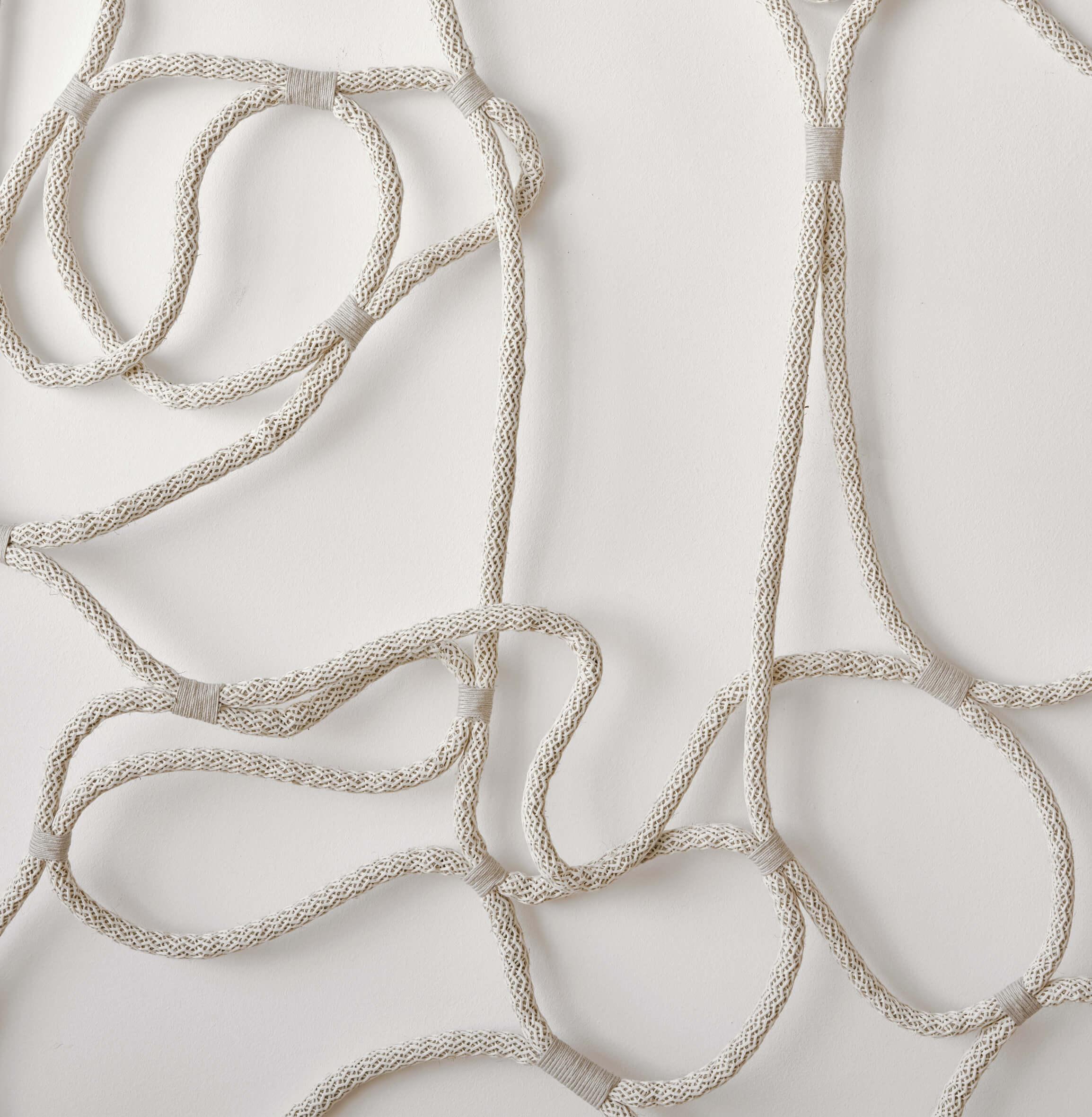White shibari ropes on a white background which are used in kink and bdsm acts of bondage